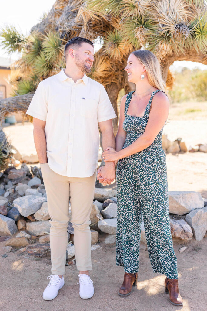 Newly engaged couple smiles at each other at Joshua Tree, California