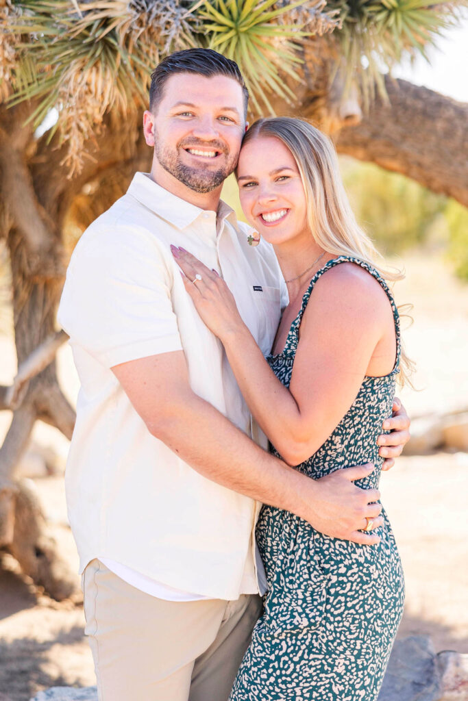 Engaged couple smiles during photoshoot at Joshua Tree, California