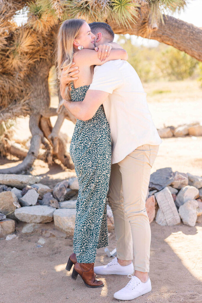 Newly engaged couple hugging in excitement at Joshua Tree