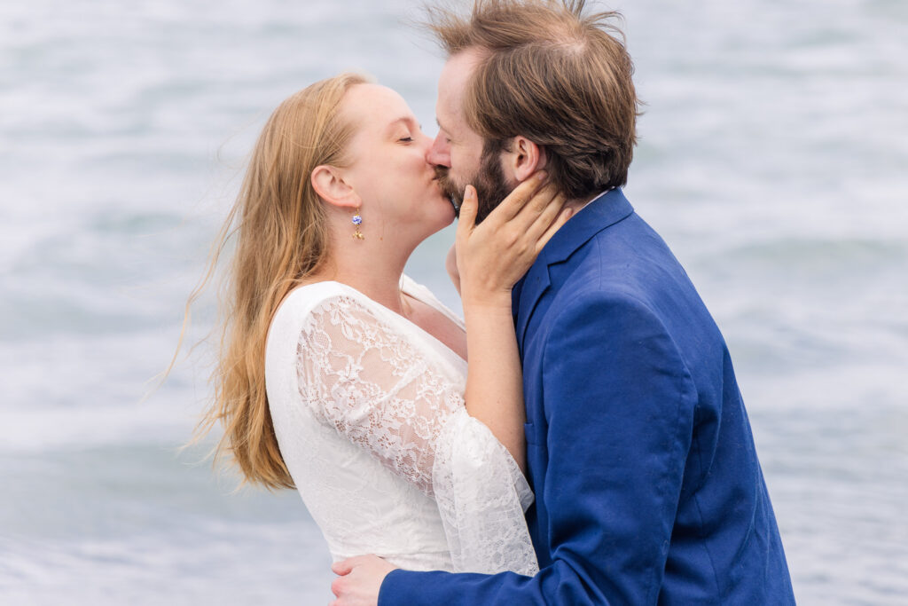 Wedding couple kisses on beach in Seward, Alaska during elopement