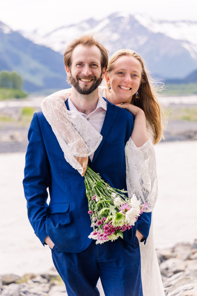 Wedding couple smiles in front of Exit Glacier during Alaska elopement