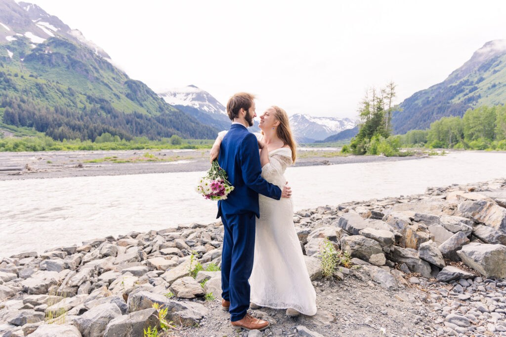 Wedding couple smiles in front of Exit Glacier during Alaska elopement