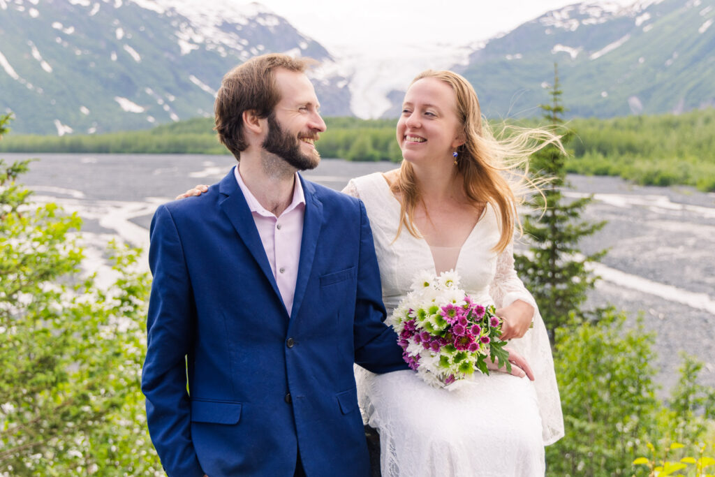 Wedding couple smiles in front of Exit Glacier during elopement in Seward, Alaska