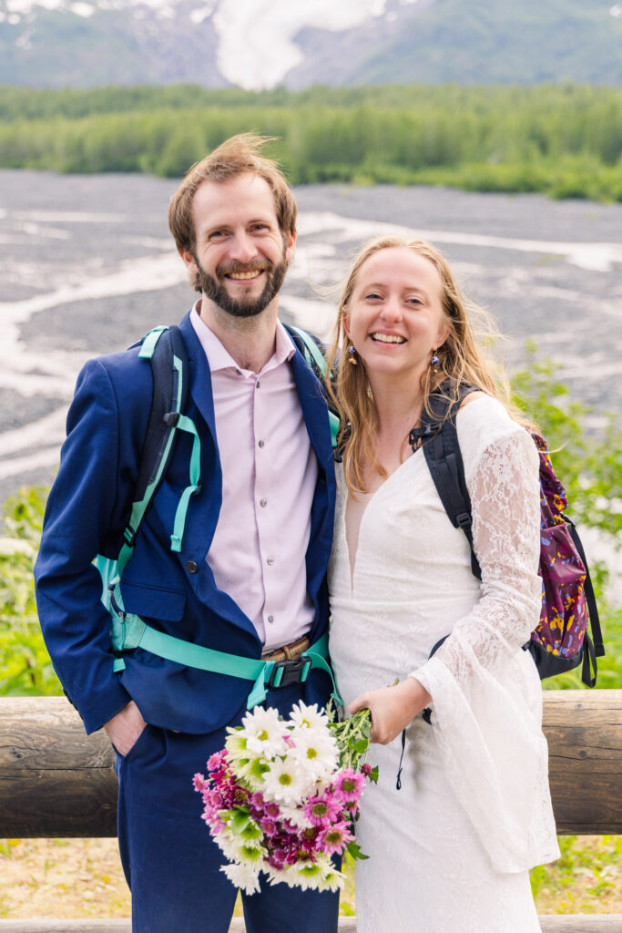 Wedding couple smiles in front of Exit Glacier during Alaska elopement