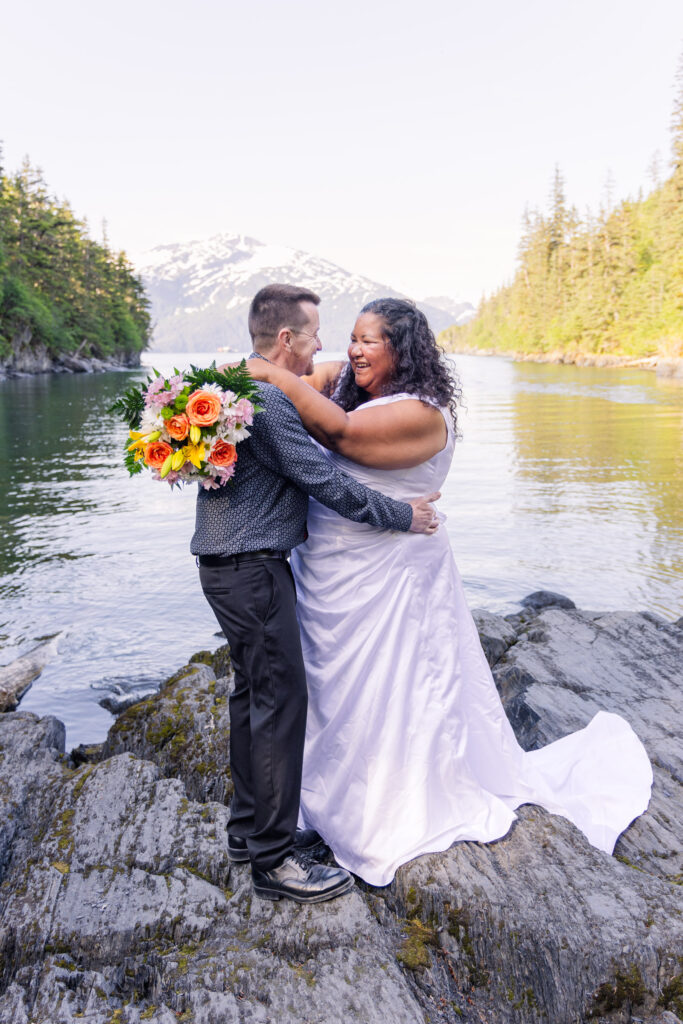 Couple eloping in front of mountain and lake in Whittier, Alaska