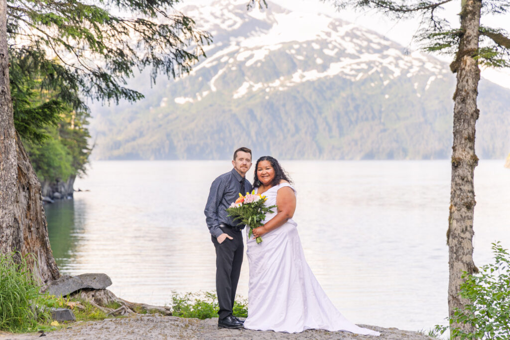 Couple eloping in front of mountain and lake in Whittier, Alaska