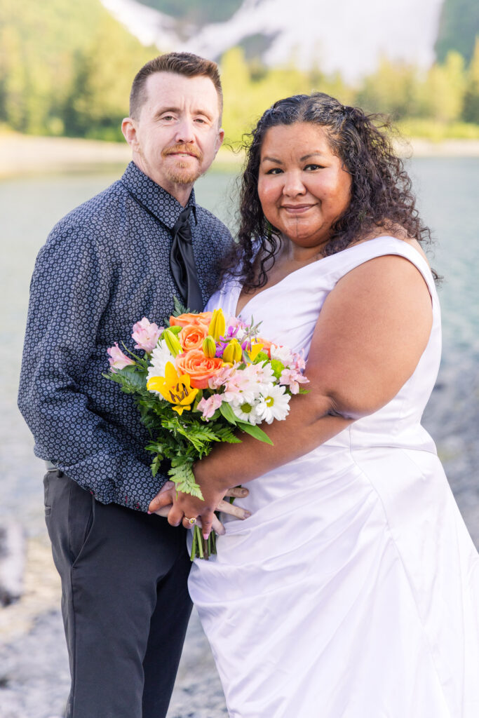 Couple eloping in front of glacier and mountain in Whittier, Alaska