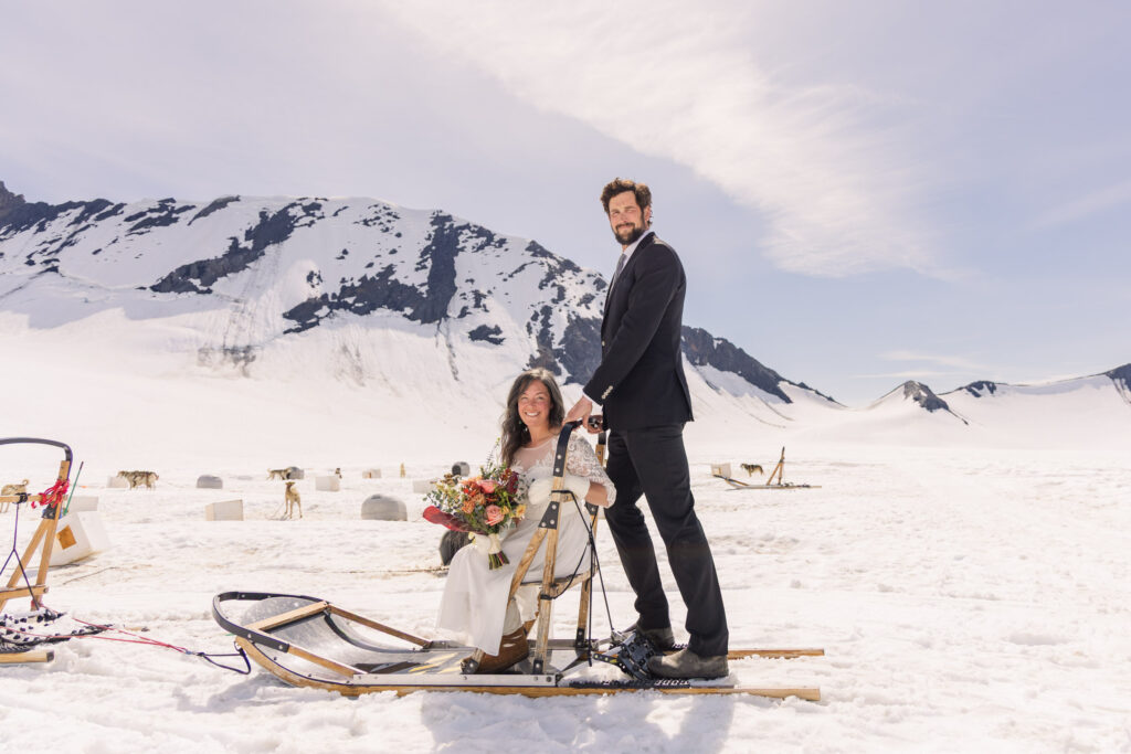 Couple portraits with dogsled during Alaska dogsledding elopement