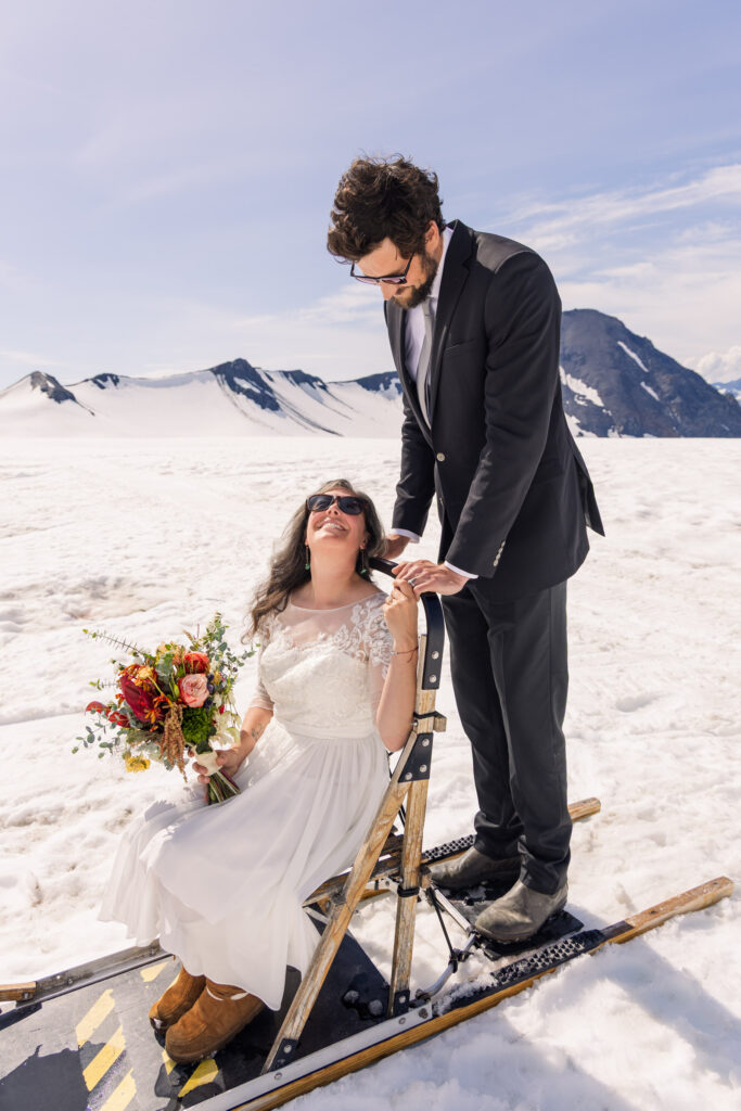 Couple portraits with dogsled during Alaska dogsledding elopement