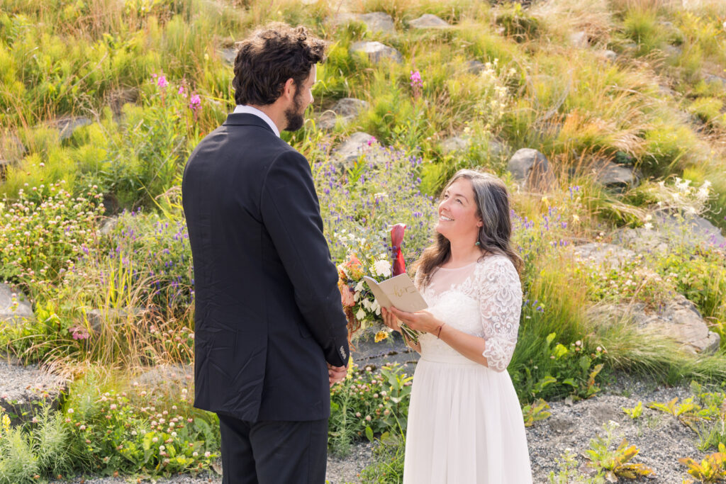 Bride gazing lovingly at groom during intimate Alaska elopement ceremony
