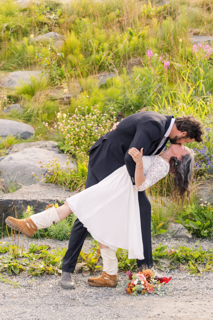 Bride and groom's first kiss during Alaska elopement wedding ceremony