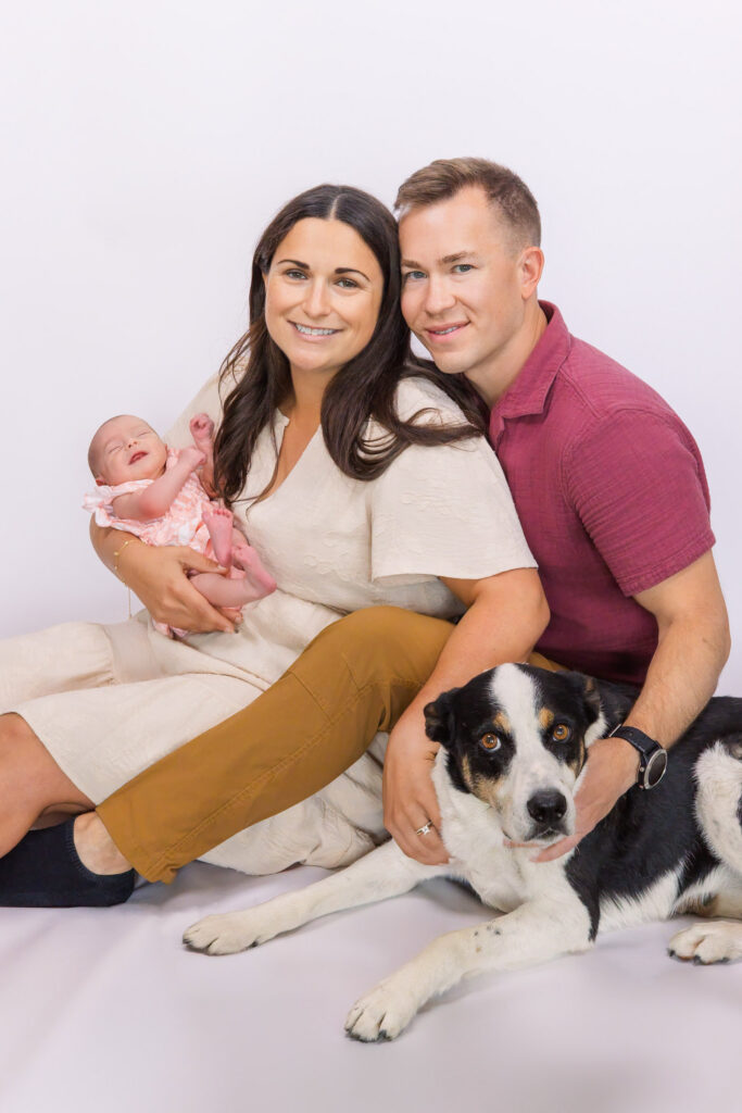 studio family photo with newborn and dog using portable studio setup