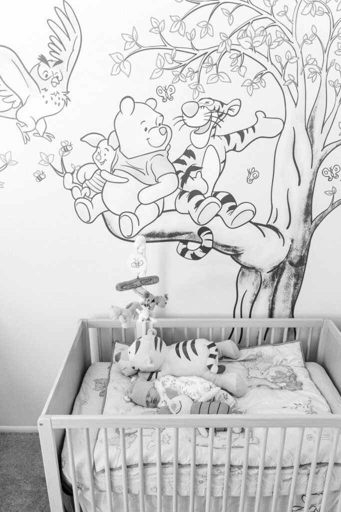 baby in winnie the pooh themed nursery