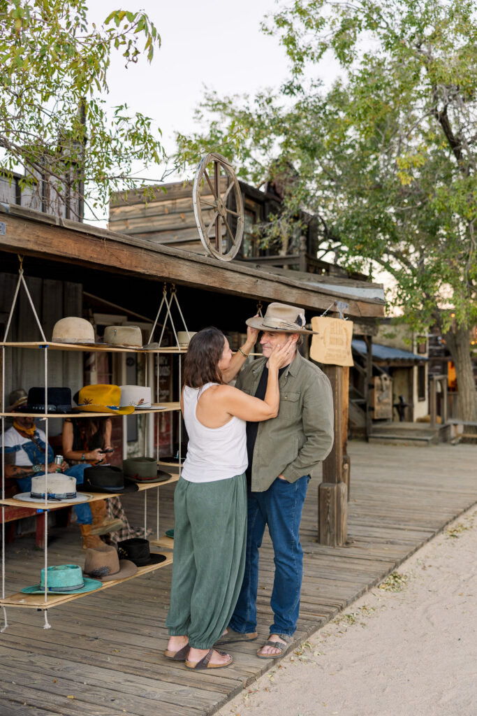 David and Lisa trying on cowboy hats at Helm Hatters in Pioneertown.