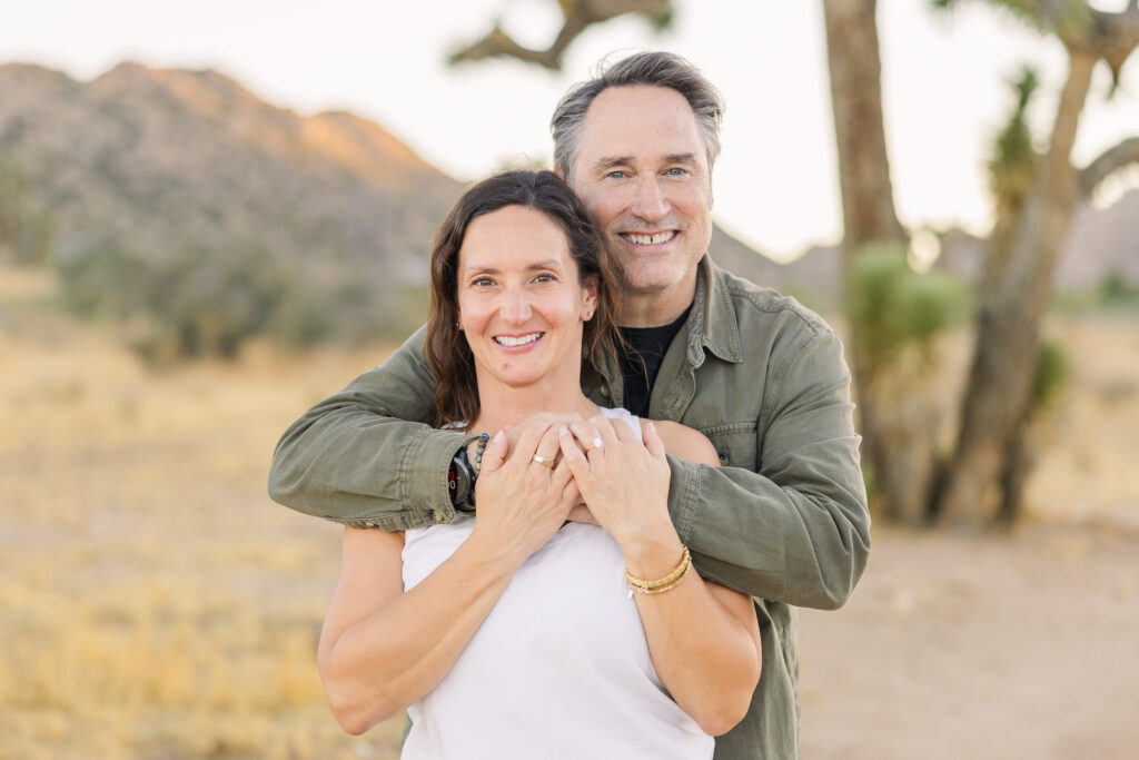 David and Lisa sharing a quiet moment together during their sunset engagement photos in front of Joshua trees.