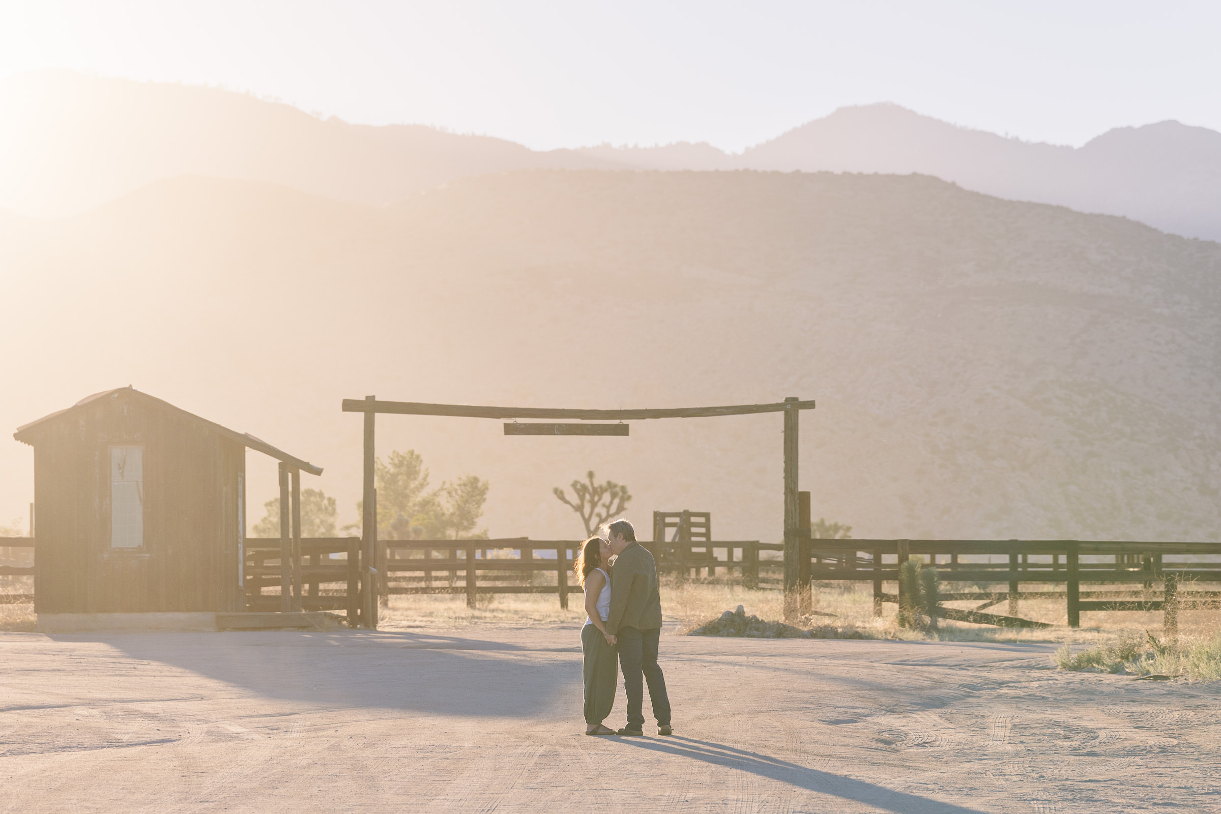 David and Lisa enjoying golden-hour engagement portraits in the desert after their Pioneertown proposal.